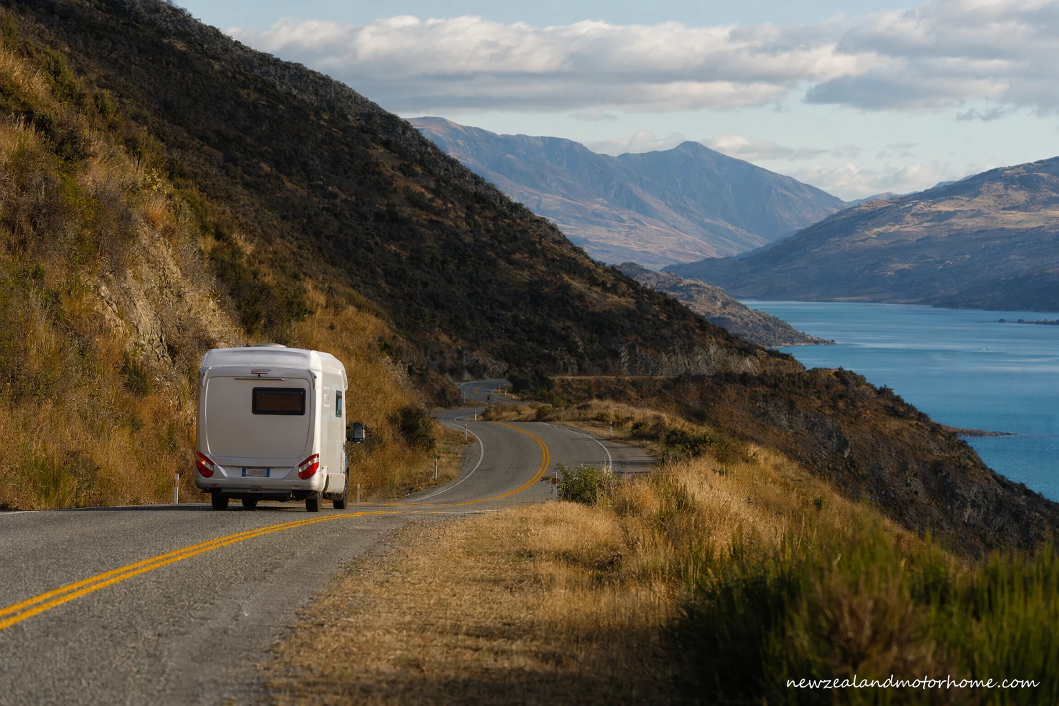 Campervan parked near Nelson with Tasman Bay hills in the background