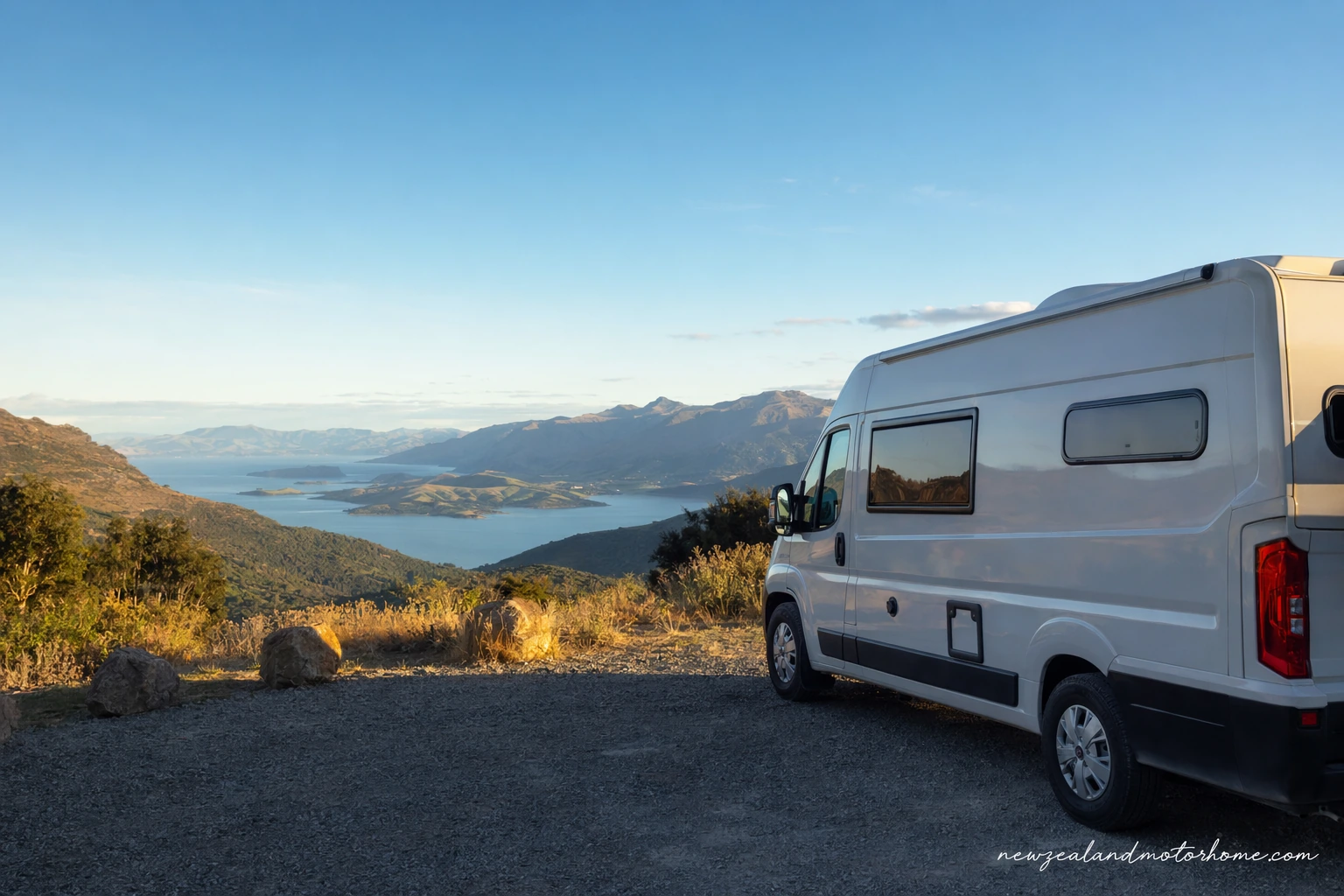 Campervan parked above Queen Charlotte Sound in Marlborough with sheltered bays and forested hills