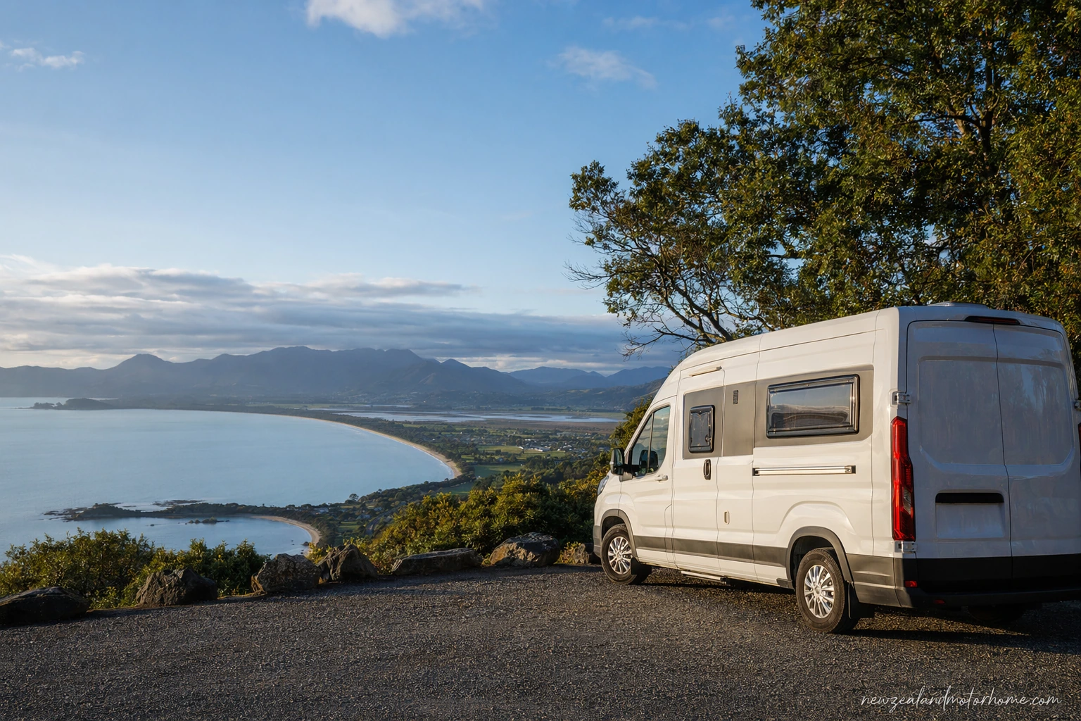 Campervan parked near the coast in Nelson Tasman with beach and hills beyond