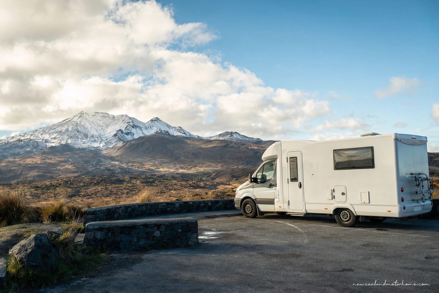 Campervan parked near Tongariro National Park with Mount Ruapehu and tussock landscape in view