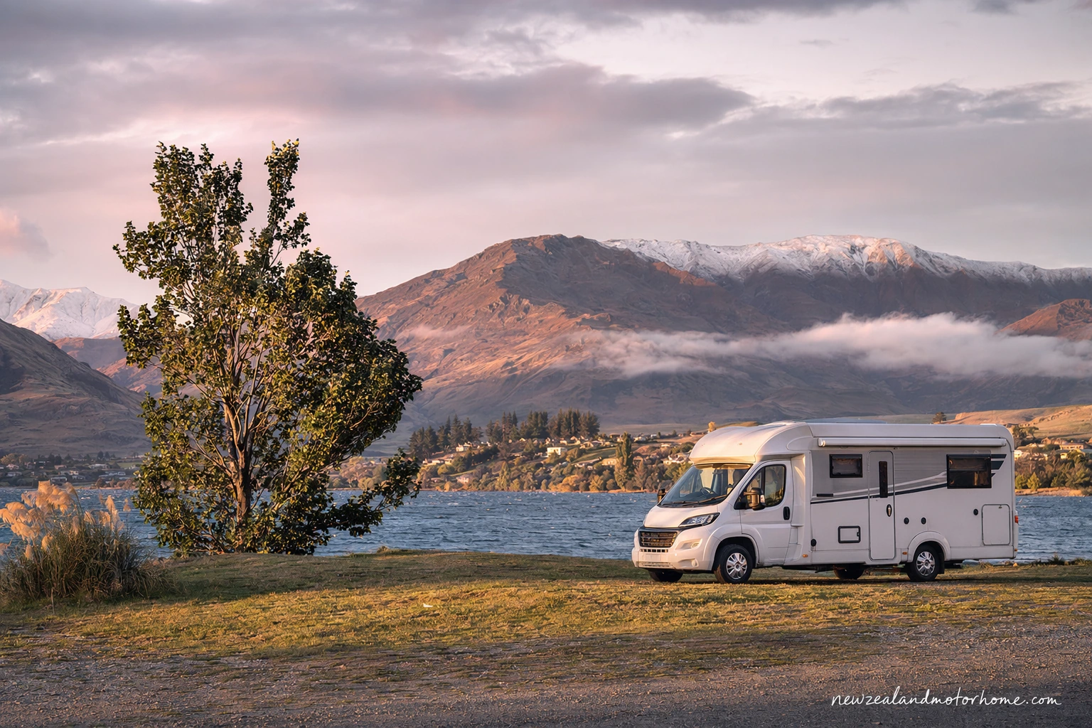 Campervan parked near Lake Wanaka with mountain views in the background