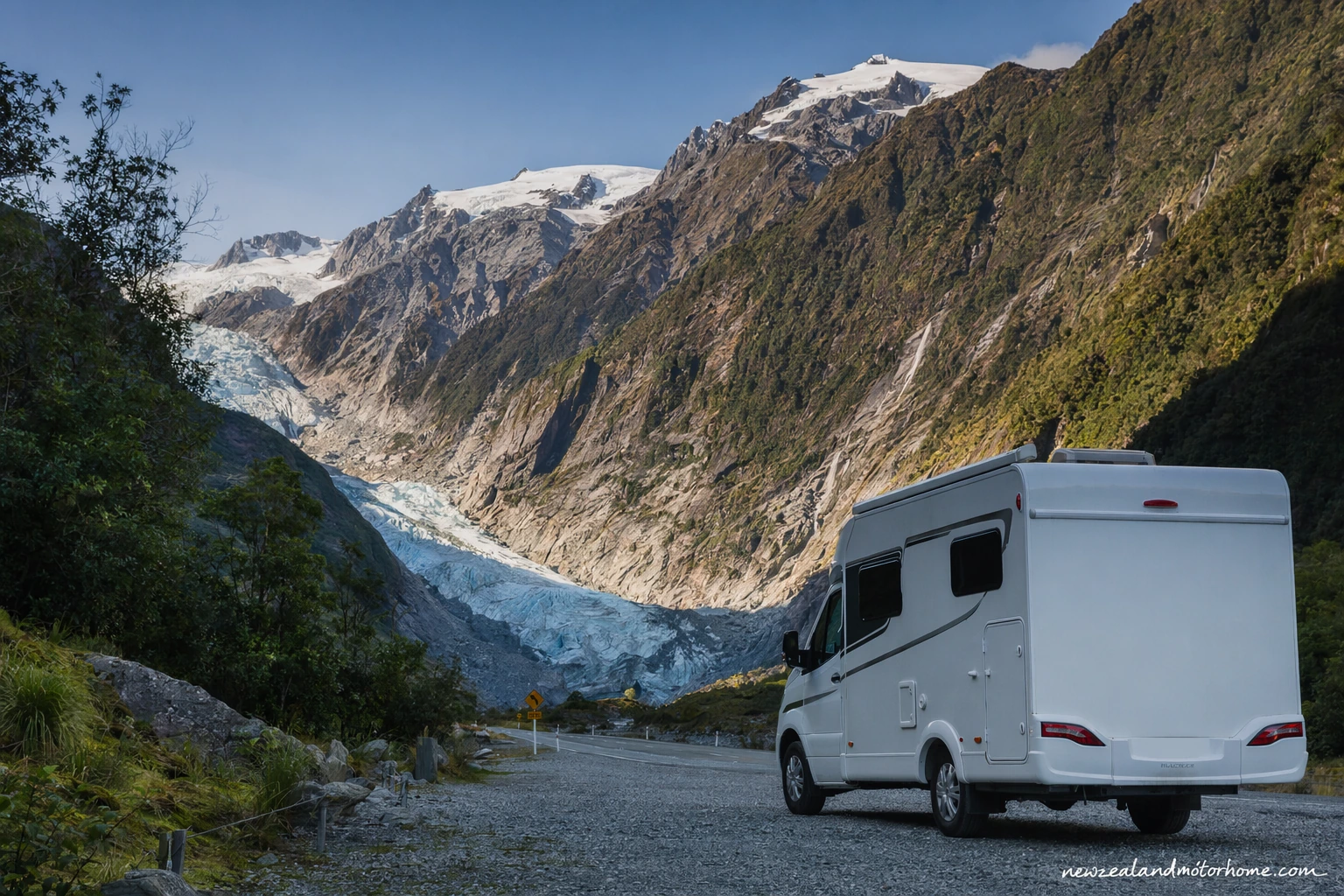 Campervan parked near Fox Glacier with West Coast rainforest and snow-capped mountains in the background