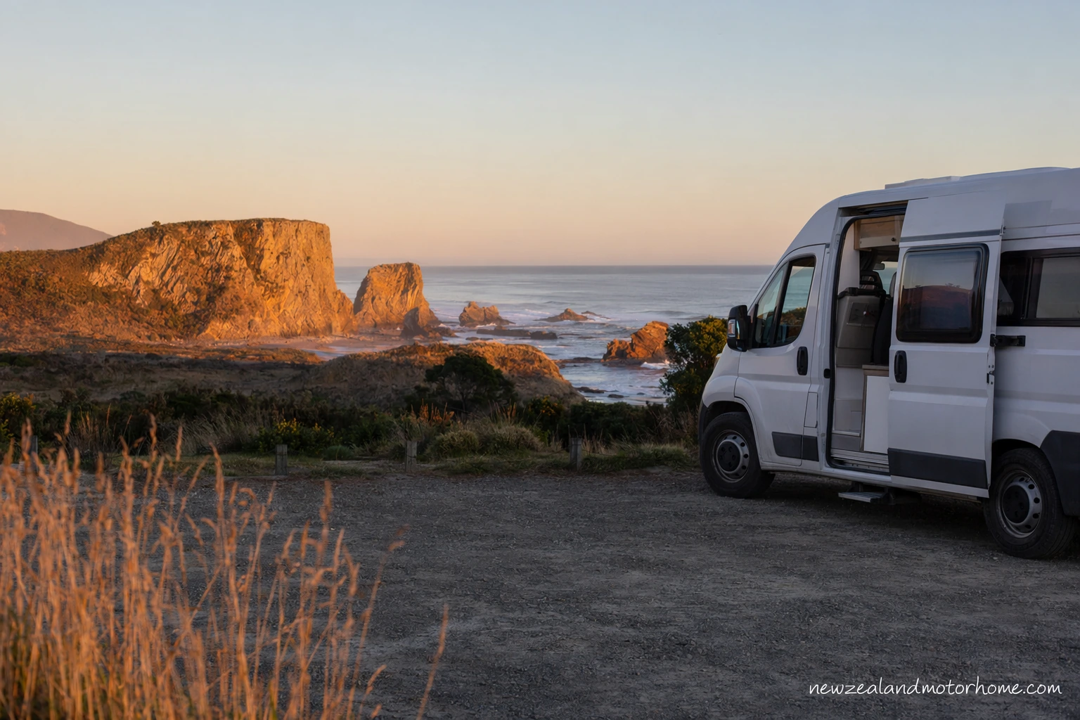 Campervan parked near the coast in Nelson with Tasman Bay in the background