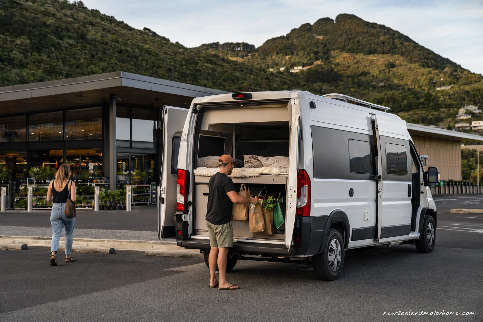 Campervan parked near Dunedin harbour while travellers stock up on supplies