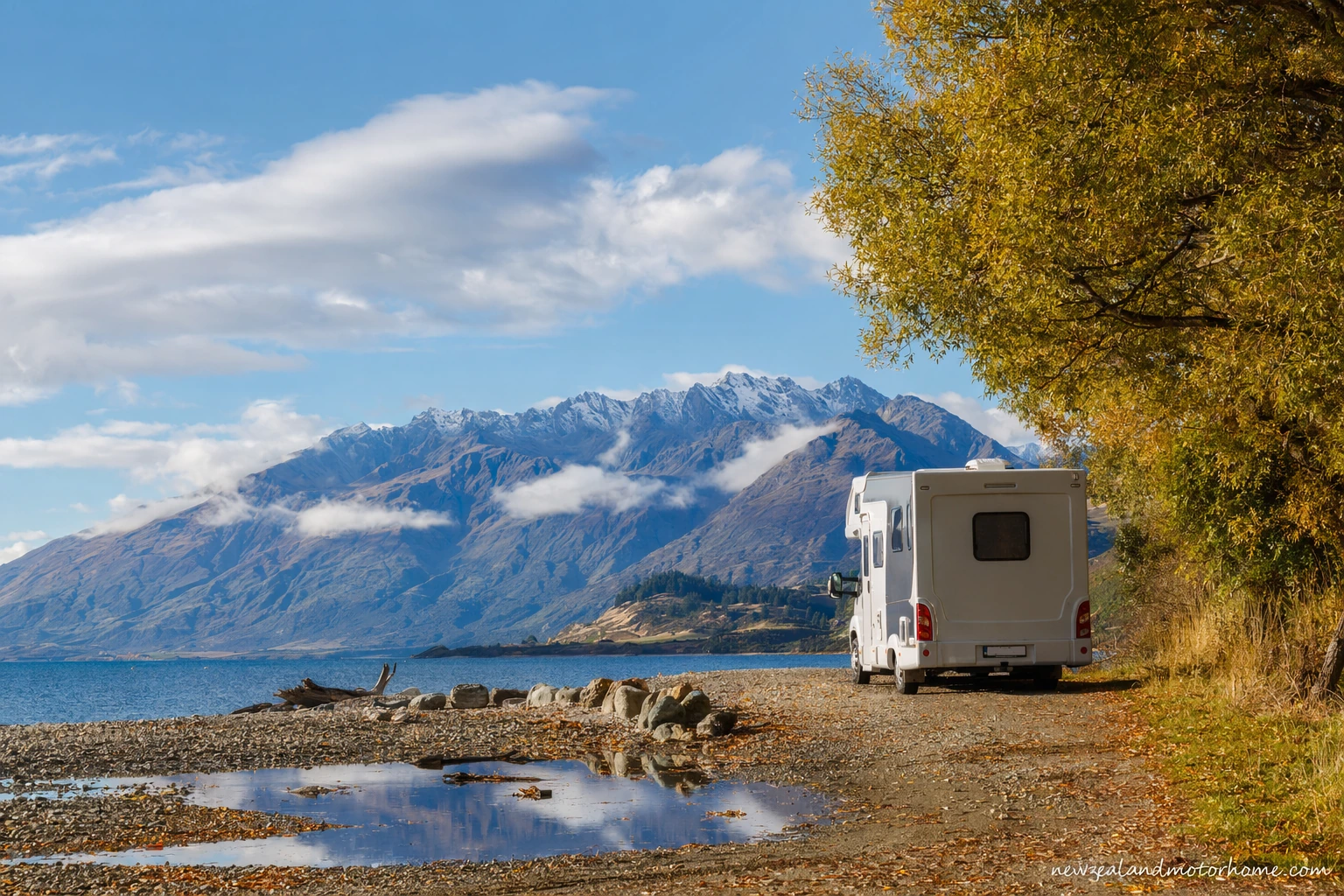 Campervan parked beside Lake Pukaki with Aoraki Mount Cook in the distance on a clear March afternoon