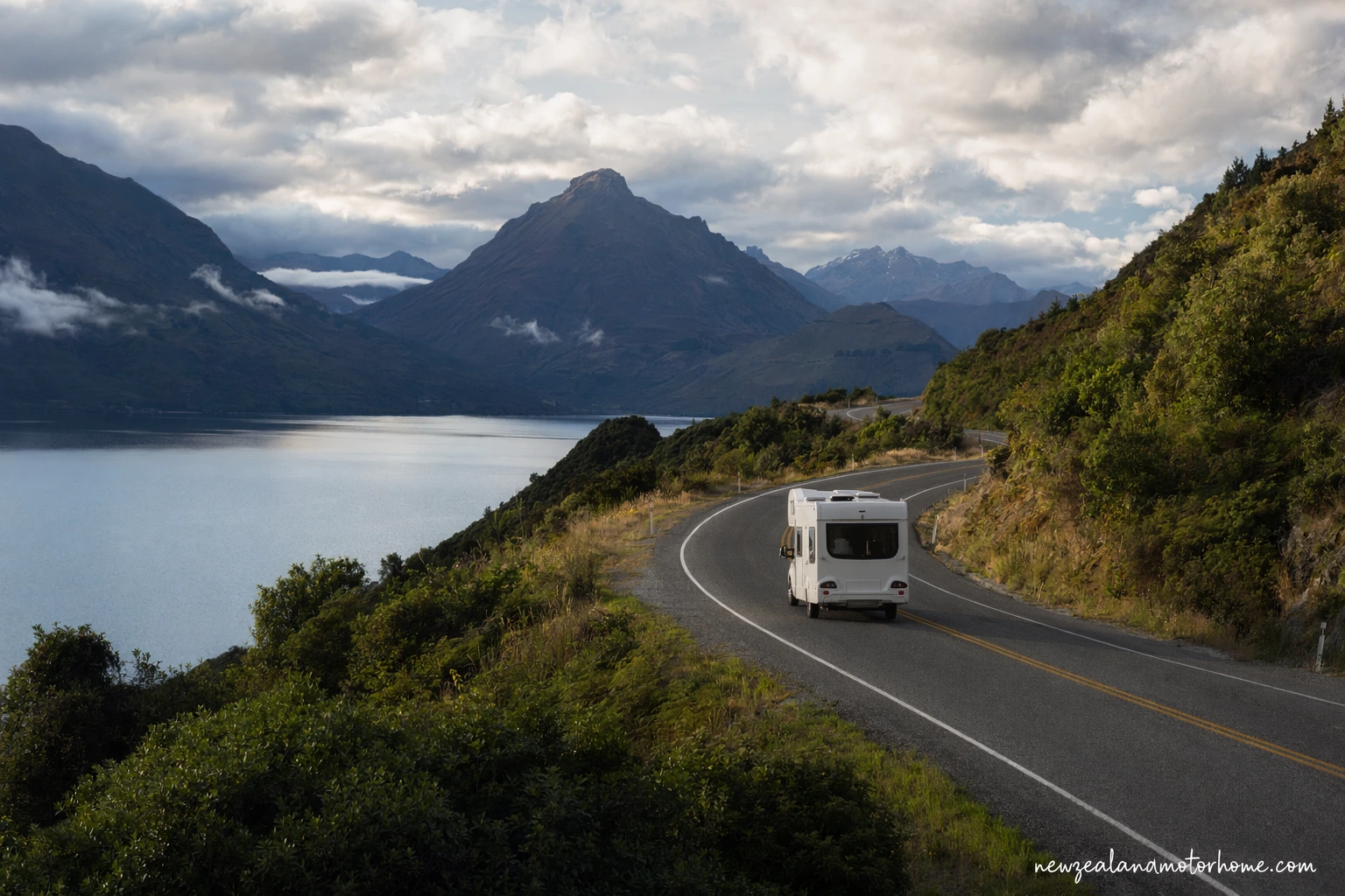 Campervan parked beside the lakeshore near Rotorua after the drive north from Dunedin