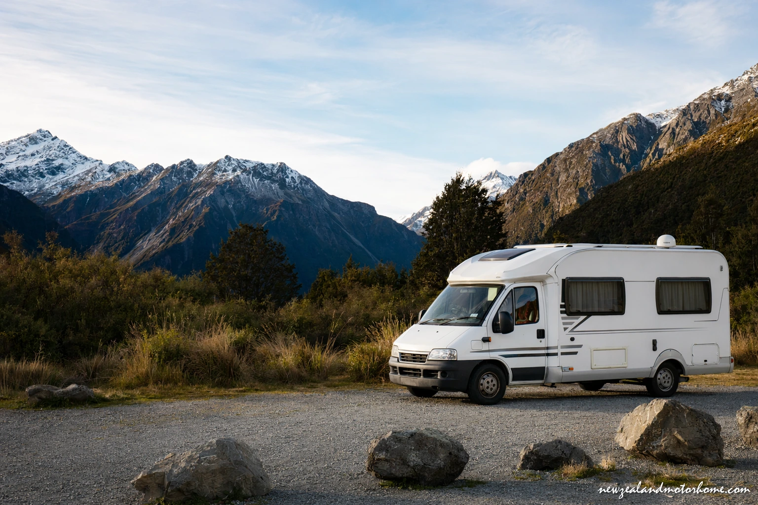 Campervan parked near Arthur's Pass with alpine mountains and beech forest beside State Highway 73