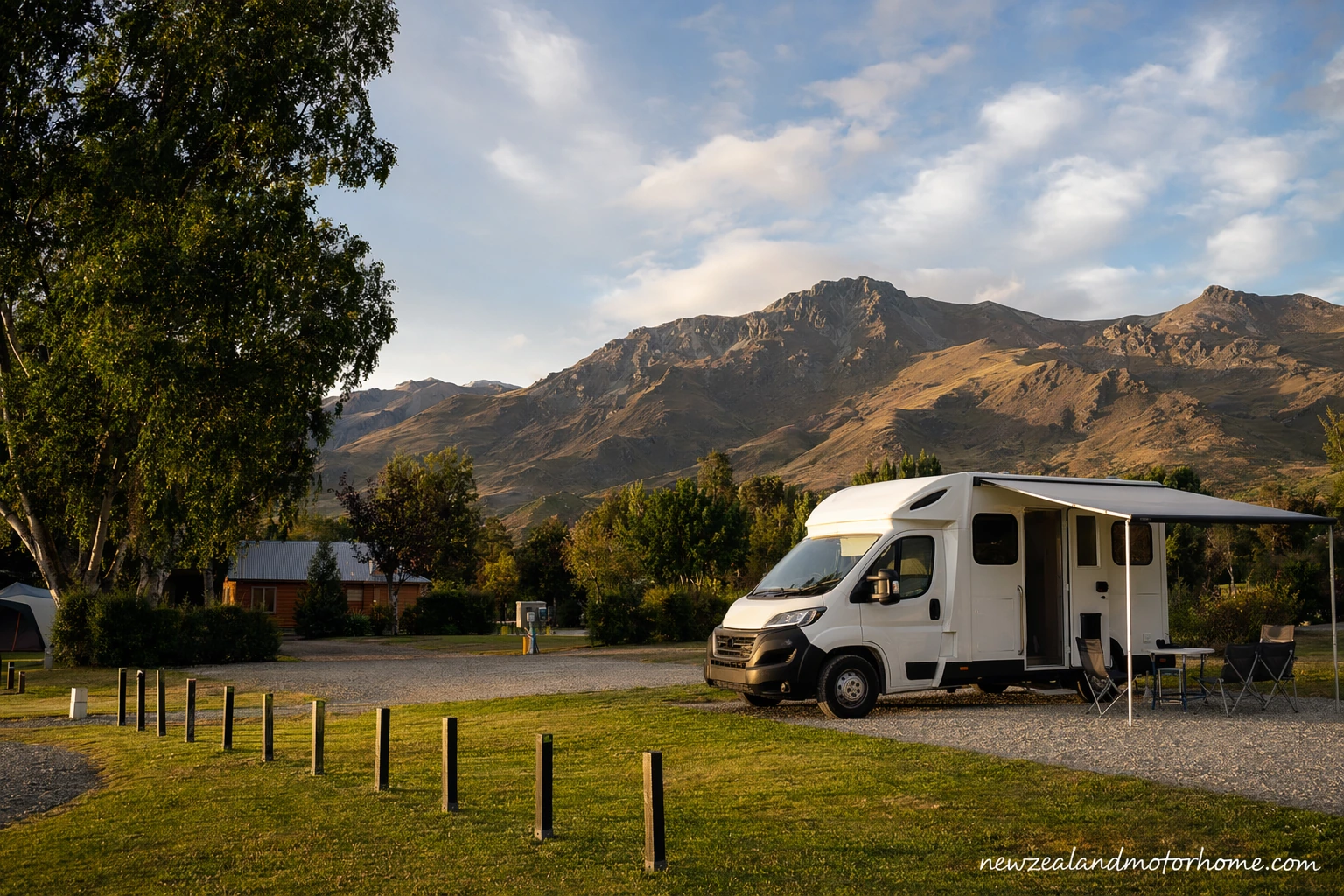 Campervan parked at a Central Otago holiday park with dry hills and wide inland sky