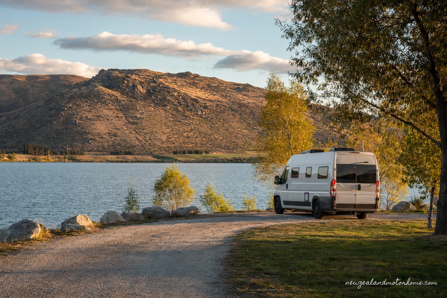 Campervan parked near Lake Dunstan in Cromwell with Central Otago hills in the background