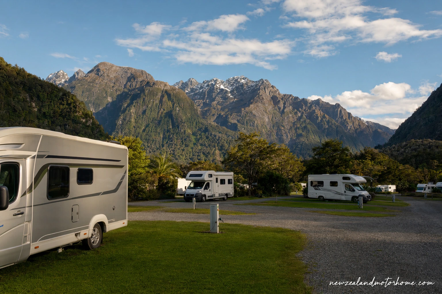 Campervan parked beside Lake Te Anau with Fiordland mountains in the background