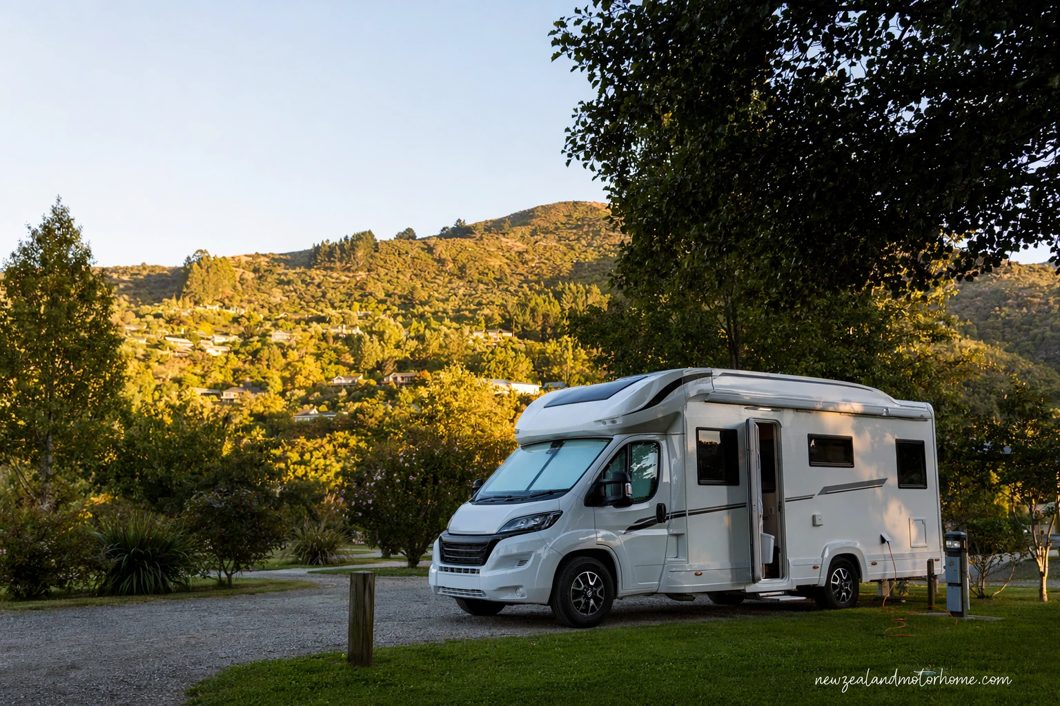 Campervan parked near Tahunanui Beach in Nelson with holiday park sites and Tasman Bay nearby