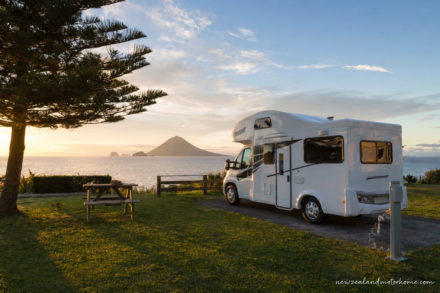 Campervan parked near the New Plymouth coast with the Coastal Walkway and Taranaki Maunga in the distance