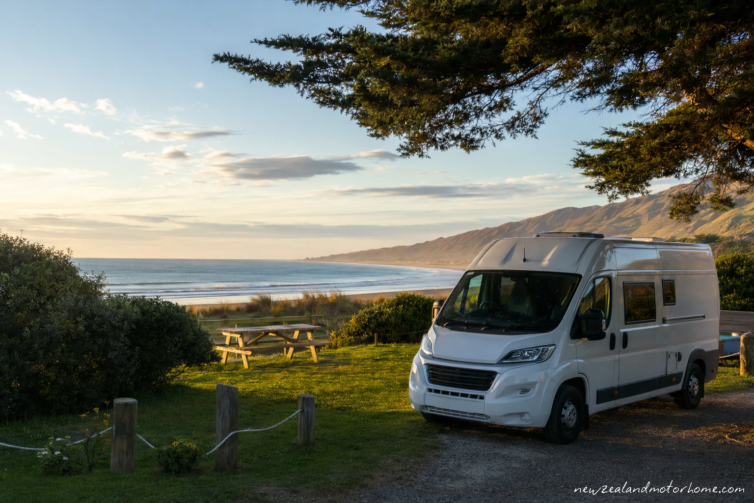 Campervan parked near the dunes and wide sand of Ninety Mile Beach in Northland