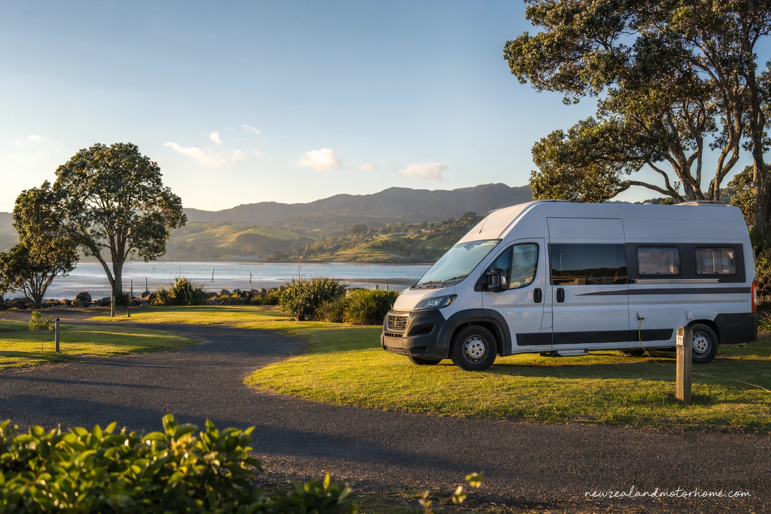 Campervan parked at a green holiday park site near Whangārei in Northland