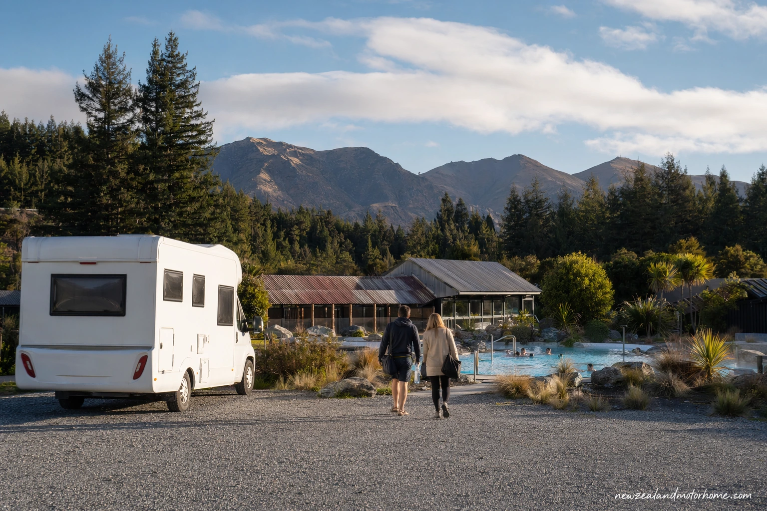 Campervan parked in Hanmer Springs village near the thermal pools with mountains behind