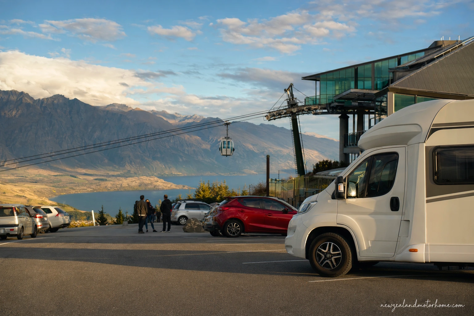Campervan parked above Queenstown with the Skyline Queenstown Gondola rising up the hillside