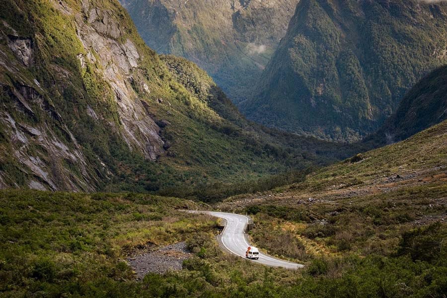 A Britz campervan driving on the road to Milford Sound